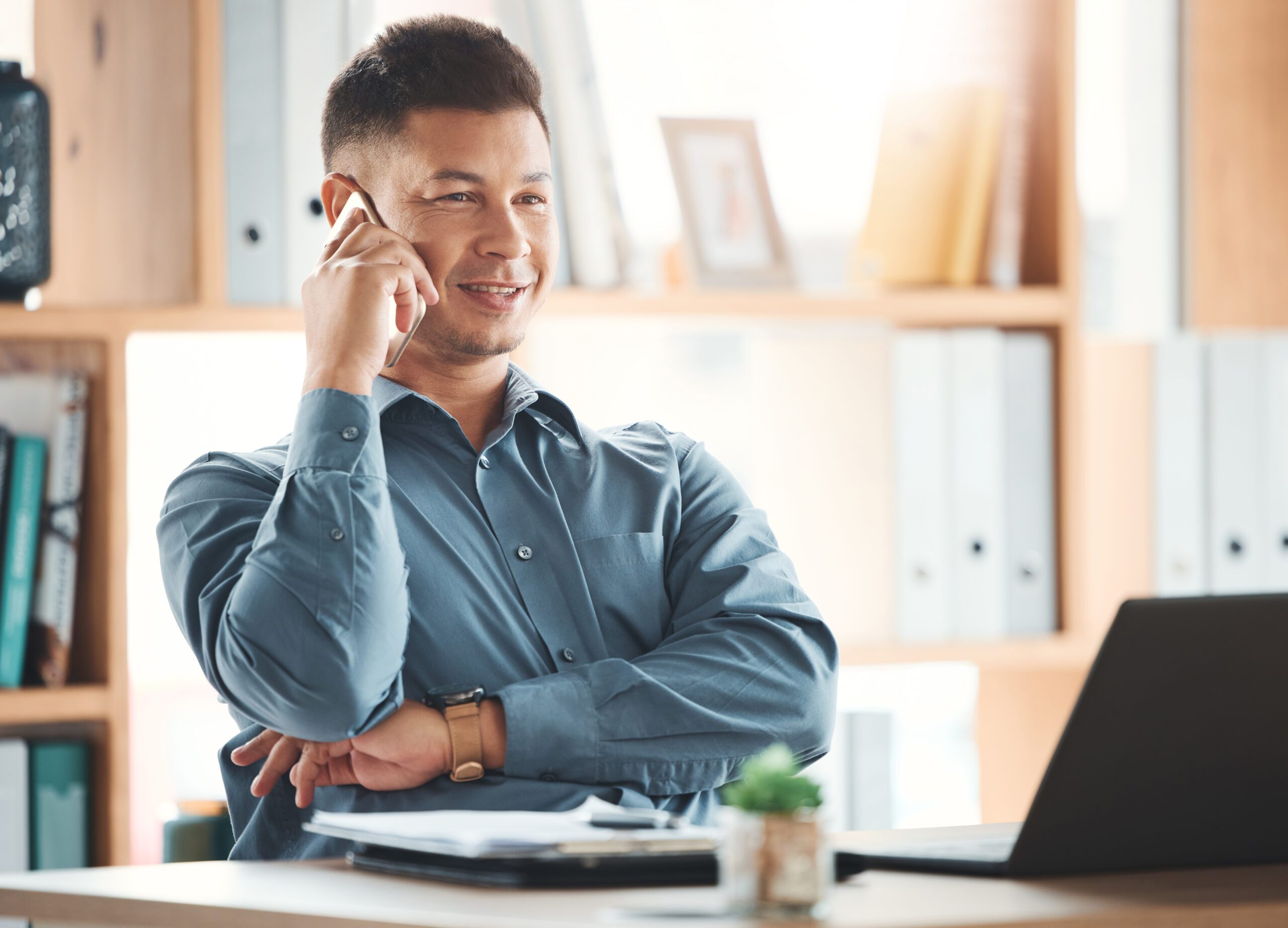 Office, laptop and man on phone call at desk with smile